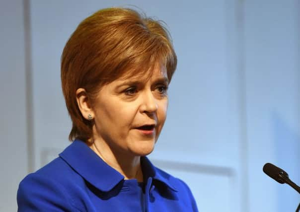 Nicola Sturgeon listens as her Bexit Minister Michael Russell speaks during the Scottish Parliament debate on the triggering of Article 50 (Photo: PA)