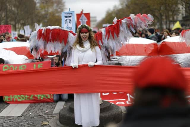 Protesters in the French capital form a red line that summit negotiators should not cross. Picture: Matt Dunham/AP