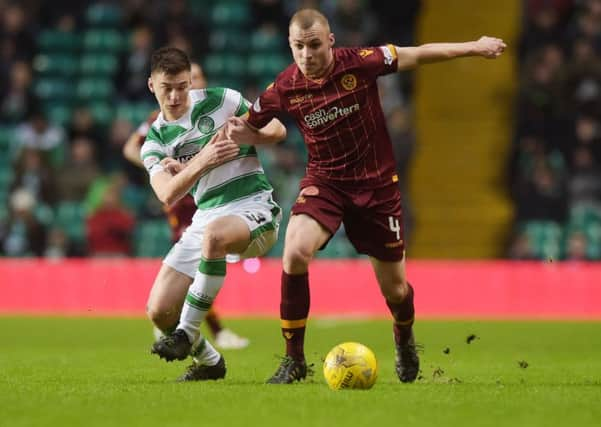 Celtic's Kieran Tierney, left, battles Motherwell's Liam Grimshaw. Picture: SNS