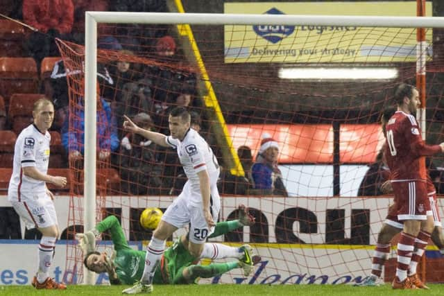 Liam Polworth (centre) wheels away after scoring the opening goal. Picture: SNS Group