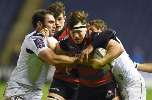 Edinburgh's Hamish Watson (centre) battles through a pair of tackles. Picture: SNS