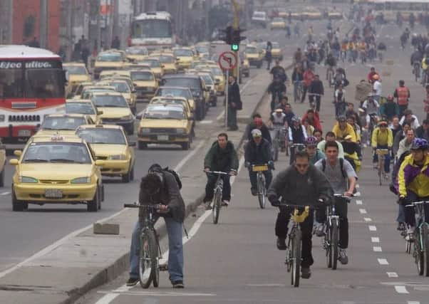 Commuters in Bogota, Colombia. IndigoVision is involved in 'safe city' projects across the South American country. Picture: AP Photo/Ricardo Mazalan