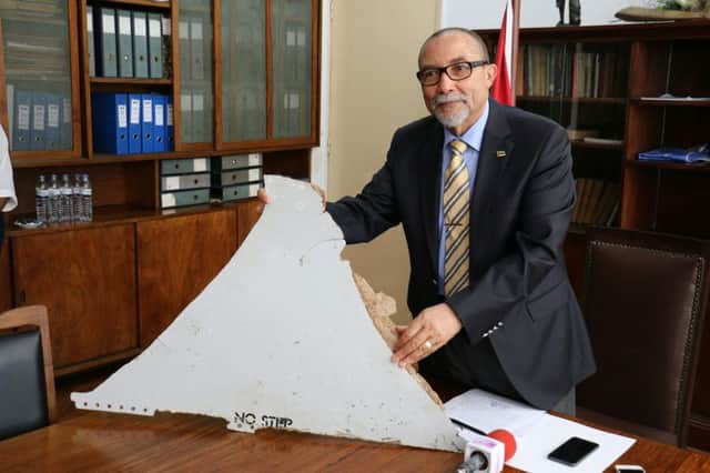 Joao de Abreu, president of Mozambiques Civil Aviation Institute, holds a piece of aircraft wreckage thought to have come from flight 370. Picture: AFP/Getty Images