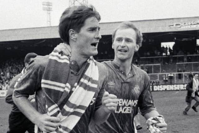 Brown, right, celebrates winning the title in 1990 with Rangers team-mate Richard Gough. Picture: SNS
