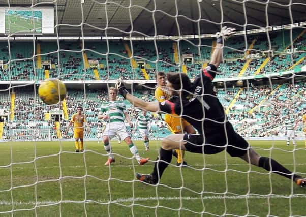 Celtics Gary Mackay-Steven puts the ball out of reach of stretching Morton goalkeeper Derek Gaston. Picture: PA