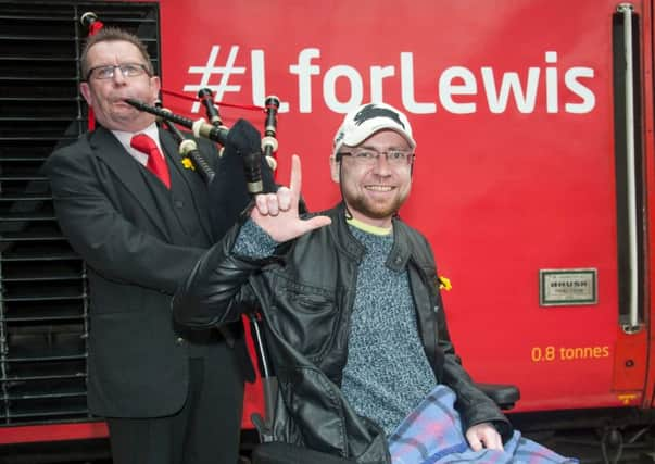 Lewis Vaughan with piper David Johnston as the train with #LForLewis arrives at Waverley Station. Picture: Andrew O'Brien