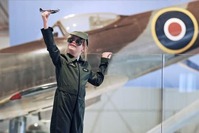 Arabella, seven, flies her own Spitfire in the newly redeveloped Hangar 2, ahead of this weekend's opening. Picture: Neil Hanna