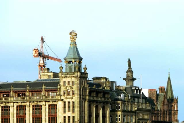 A crane towers over the openwork globe of the former RW Forsyth's department store (now Top Shop/Wallis) at the corner of South St David Street and Princes Street, Edinburgh, February 1992. Picture: Hamish Campbell