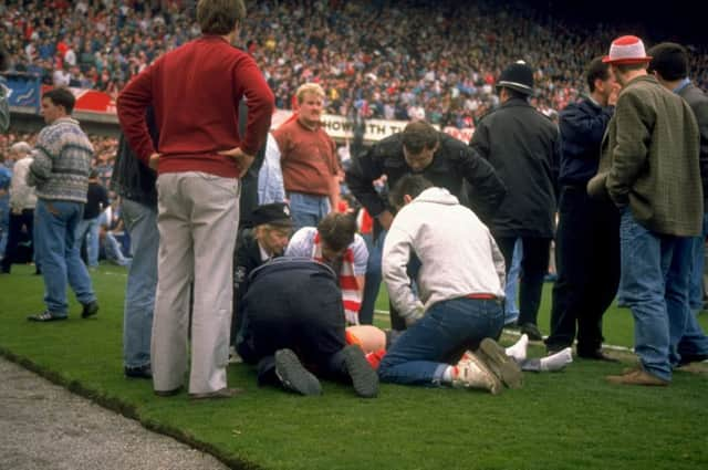 Injured supporters were laid on the pitch. Picture: David Cannon/Allsport