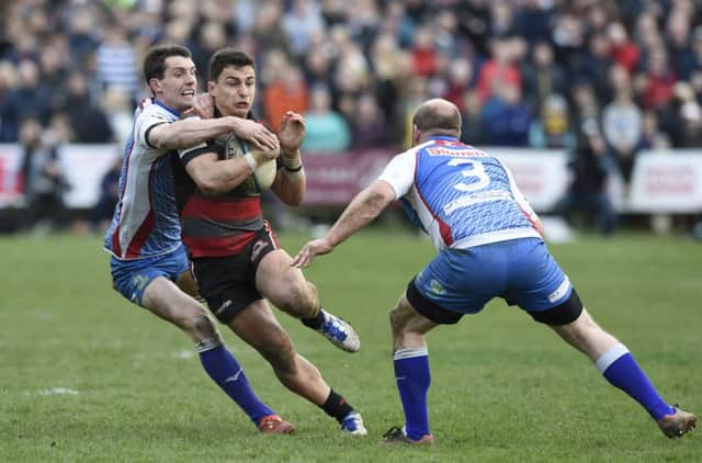 Edinburghs Damien Hoyland is tackled by Jeds Gregor Young.   Picture: Ian Rutherford