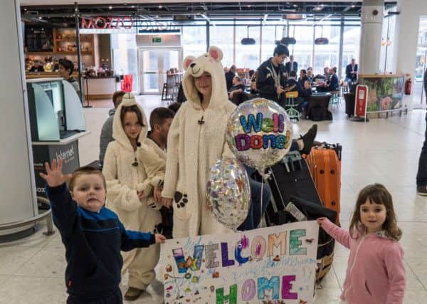 Terry Cook and kids await Polar Academy team at airport. Picture: Chris Hogg