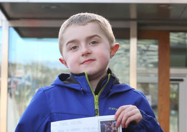 DMD patient Michael Young with the petition. Picture: Stewart Attwood/Warren Media