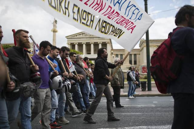 Protestors on the streets outside the Athens Academy as Greece is hit by strikes over the governments fresh austerity plans. Picture: AP