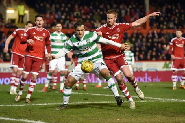 Celtic's Erik Sviatchenko holds off Aberdeen's Adam Rooney  when the Dons won at Pittodrie in February. Picture: SNS