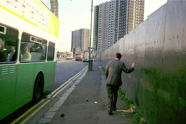 A man unsteadily makes his way through the Gorbals as a bus painted in old corporation colours passes by. Picture: Raymond Depardon/Magnum