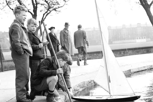 Boys sailing yachts on Inverleith Pond  Edinburgh.