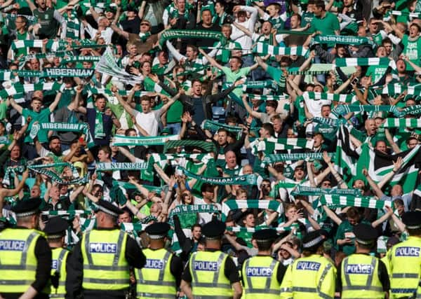 Fans celebrated on the pitch after the game