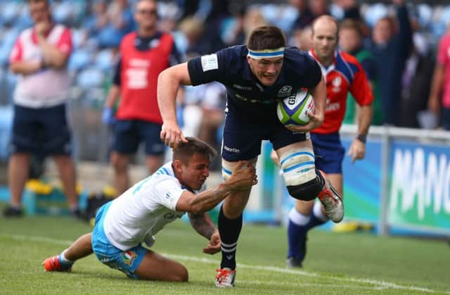 Ally Miller beats Italy's Pierre Bruno to score Scotland's fourth try in the World U20 Championship in Manchester. Picture: Dave Thompson/PA