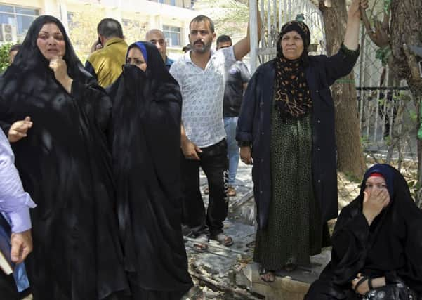 Families of the newborn babies who died in the fire gather outside the maternity ward at Yarmouk hospital in western Baghdad. Picture: AP