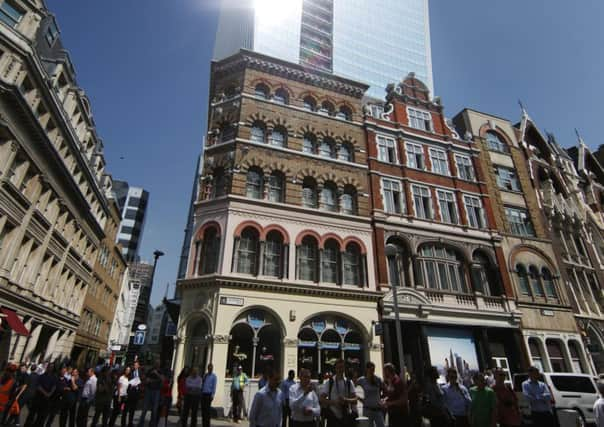 A crowd gathers as the sun reflects from a new office building in the City of London. Photograph: Peter Macdiarmid/Getty Images