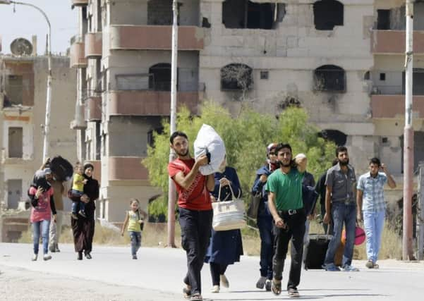 Palestinian residents choose pieces of clothing from a Turkish aid shipment, in Gaza City. Picture: AP