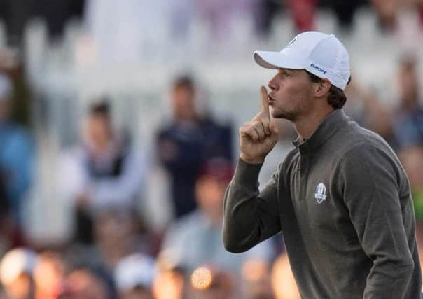 Thomas Pieters hushes the crowd after sinking a putt for an opening birdie. Photograph: Jim Watson/Getty