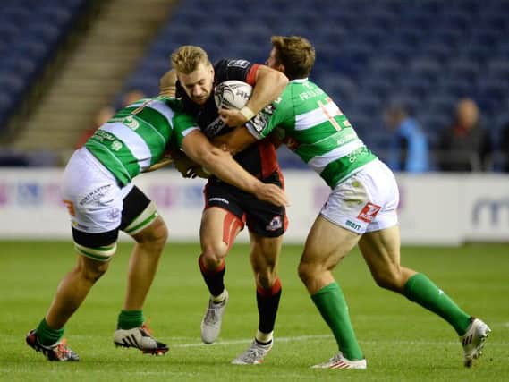 Edinburgh's Tom Brown (centre) breaks through from Treviso's Benvenuti Tommaso (right) and Buondonno Andrea. Picture: SNS