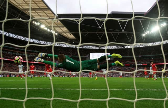 Daniel Sturridge scores his sides first goal as Maltas Andrew Hogg dives in vain.  Photograph: Nick Potts/PA