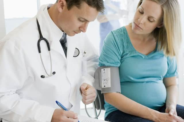 Doctor examining pregnant woman