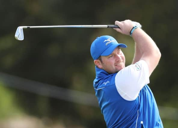 Duncan Stewart hits an approach during the opening round of the ISPS Handa World Cup of Golf in Melbourne. Picture: Getty Images