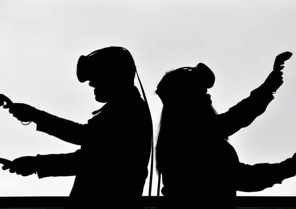 Holly Morton and Piotr Pyrchala try out gaming headsets at Scotland's first virtual reality arcade in Edinburgh. Picture: Jeff J Mitchell/Getty