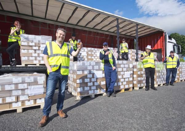 The Uisge Source team, led by Graeme Lindsay (front), raise a glass to their export success. Picture: Contributed