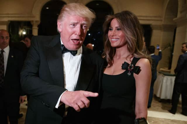 Melania Trump, right, looks on as her husband President-elect Donald Trump talks to reporters. Picture: AP