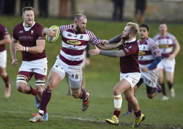 Watsonians Rory Drummond hands off Gala scrum-half Connor Adams at Myreside.  Picture: Ian Rutherford