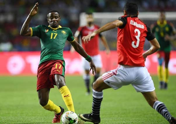 Arnaud Djoum takes on Egypts Ahmed Elmohamady. Picture: AFP/Getty.