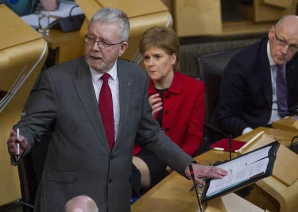 First Minister Nicola Sturgeon and Deputy First Minister John Swinney listen to Brexit Minister Michael Russell during a debate on Article 50 at Holyrood