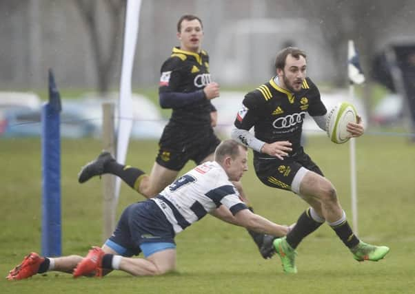 Melroses Sam Pecqueur evades the clutches of Tom Wilson as the visitors edged it.  Photograph: Greg Macvean