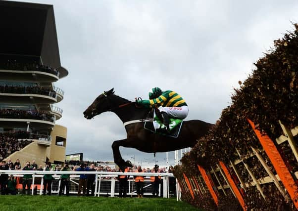 Buveur DAir, ridden by Noel Fehily, jumps the last on his way  to victory in the  Champion Hurdle. Picture: Getty.