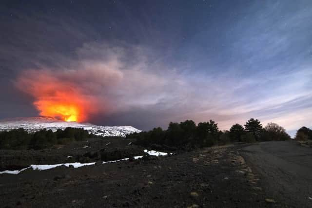 Mount Etna is seen from the side of a road as it spews lava during an eruption in the early hours of March 16. Picture: AP