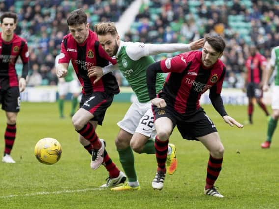 Andrew Shinnie battles for the ball with Dumbarton's Callum Gallagher and David Smith. Picture: SNS/Alan Rennie