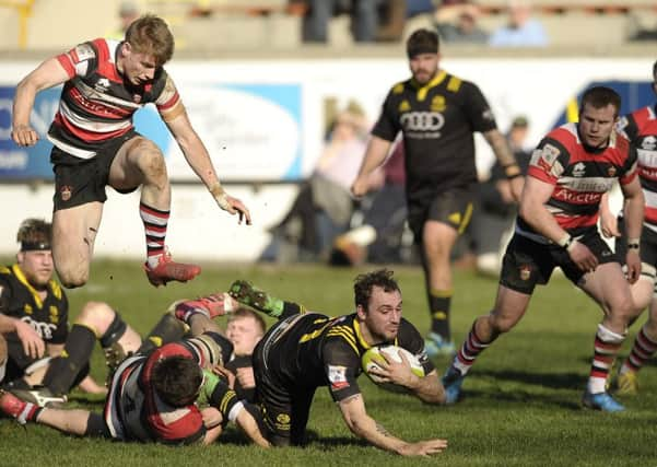 Harry Burr of Stirling County slides in to tackle Melroses Austin Lockington in yesterdays semi-final. Picture: Neil Hanna