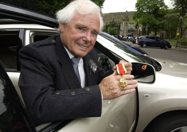 Sir Arnold Clark receiving his knighthood at the Palace of Holyroodhouse. Picture: TSPL