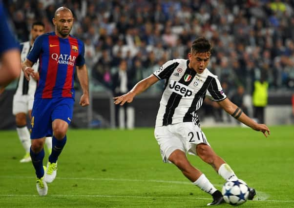 Paulo Dybala of Juventus scores his sides second goal against Barcelona last night. Picture. Getty.