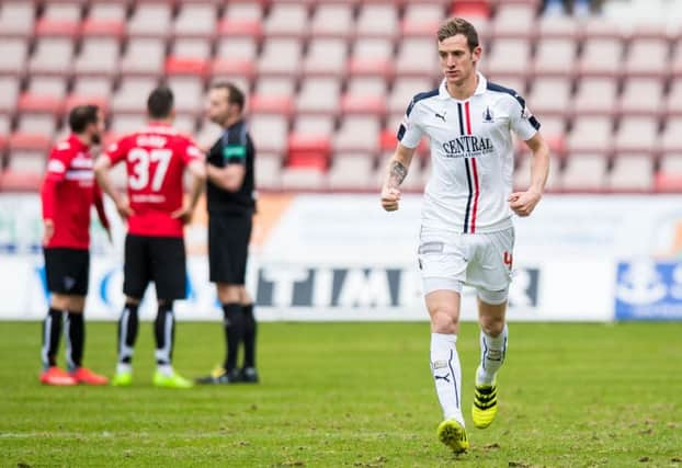 Falkirk's Aaron Muirhead celebrates his penalty as Dunfermline players protest to the referee. Pic: SNS/Ross Parker