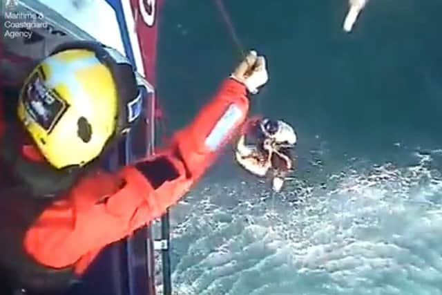 The moment surfer Matthew Bryce, who survived more than 30 hours stranded at sea on his board, was rescued. Picture: Maritime & Coastguard Agency/PA Wire