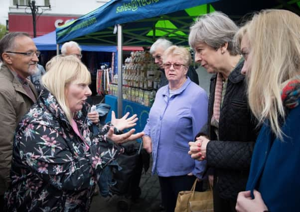 Prime Minister Theresa May meets Cathy Mohan at Abingdon market in Oxfordshire. Picture: PA