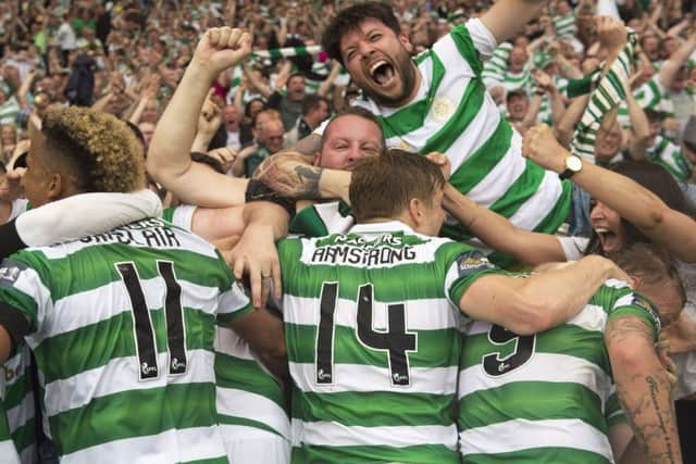 Celtic's players and fans celebrate the winning goal by Tom Rogic. Pic: SNS/Craig Williamson