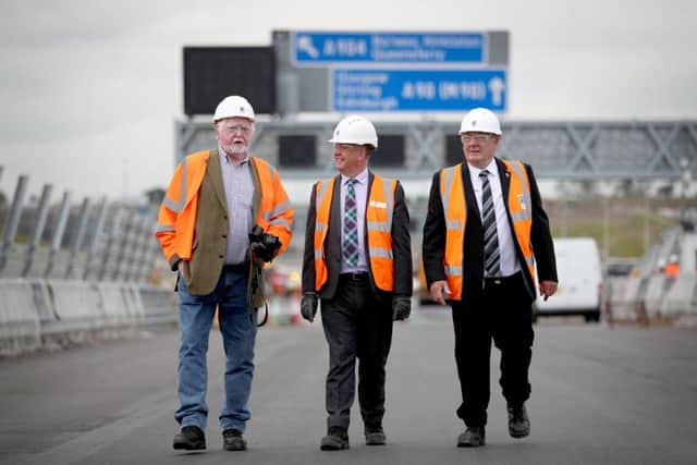 Economy secretary Keith Brown MSP (centre) with retired engineers who worked on the Forth Road Bridge over 50 years ago Alex Porteous, 71, (left) and George Barnett, 72, on the road deck of the Queensferry Crossing. Picture: Jane Barlow/PA Wire