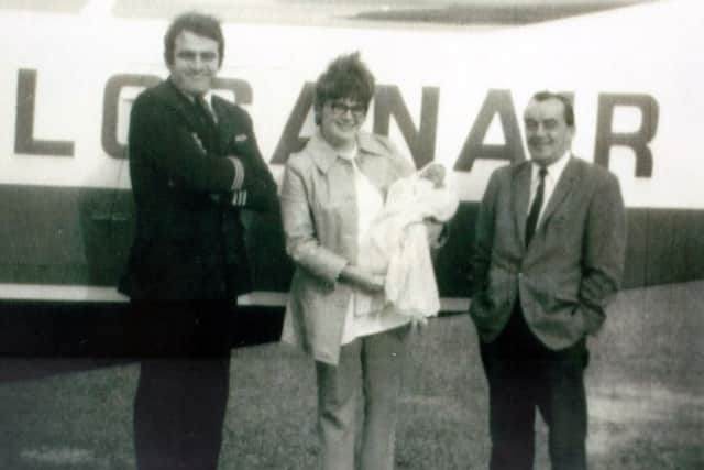 Freida Devin with newly born Katy, now mum of Chloe Stott, who has just qualified as Loganair Cabin Crew, with pilot Captain Jamie Bailey (left) and Dr Ferguson. Picture: PA