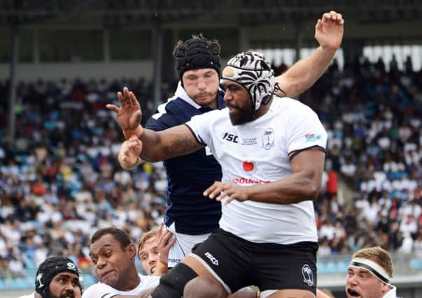 Opening try scorer Peceli Yano gets in front of Tim Swinson. Picture: AFP/Getty